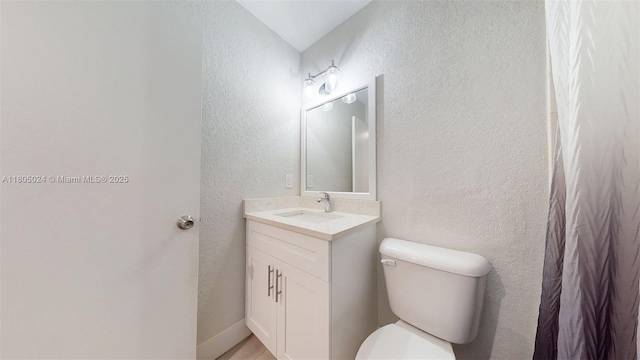 15805 W Waterside Cir Unit 202, Sunrise, FL 33326 - bathroom featuring toilet, vanity, and a textured wall