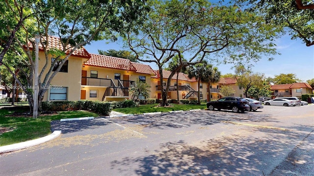 15805 W Waterside Cir Unit 202, Sunrise, FL 33326 - view of building exterior with uncovered parking and a residential view