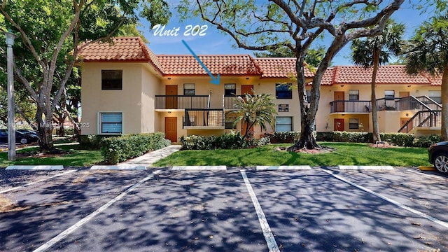 15805 W Waterside Cir Unit 202, Sunrise, FL 33326 - view of property featuring uncovered parking
