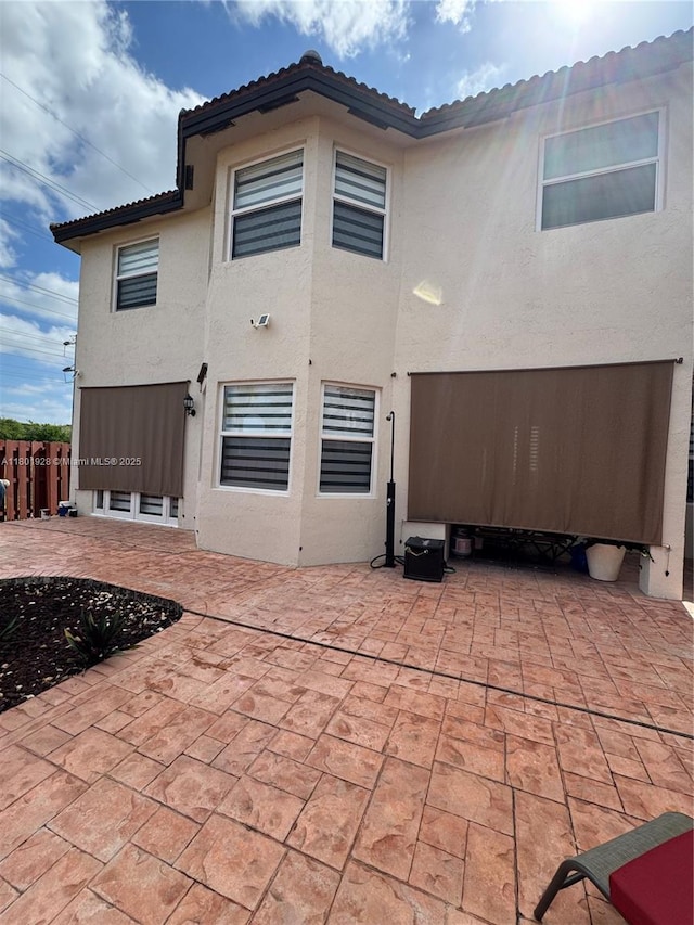 4892 NW 109th Pl, Doral, FL 33178 - rear view of house featuring a patio area, stucco siding, fence, and a tile roof