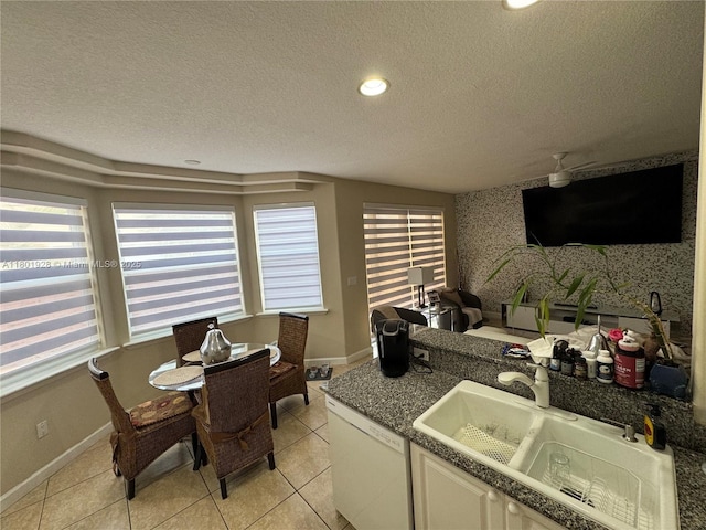 4892 NW 109th Pl, Doral, FL 33178 - kitchen with a sink, dishwasher, a textured ceiling, healthy amount of natural light, and white cabinets