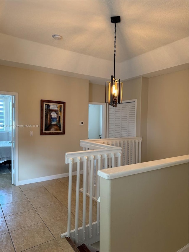 4892 NW 109th Pl, Doral, FL 33178 - corridor with an upstairs landing, a chandelier, light tile patterned floors, and baseboards