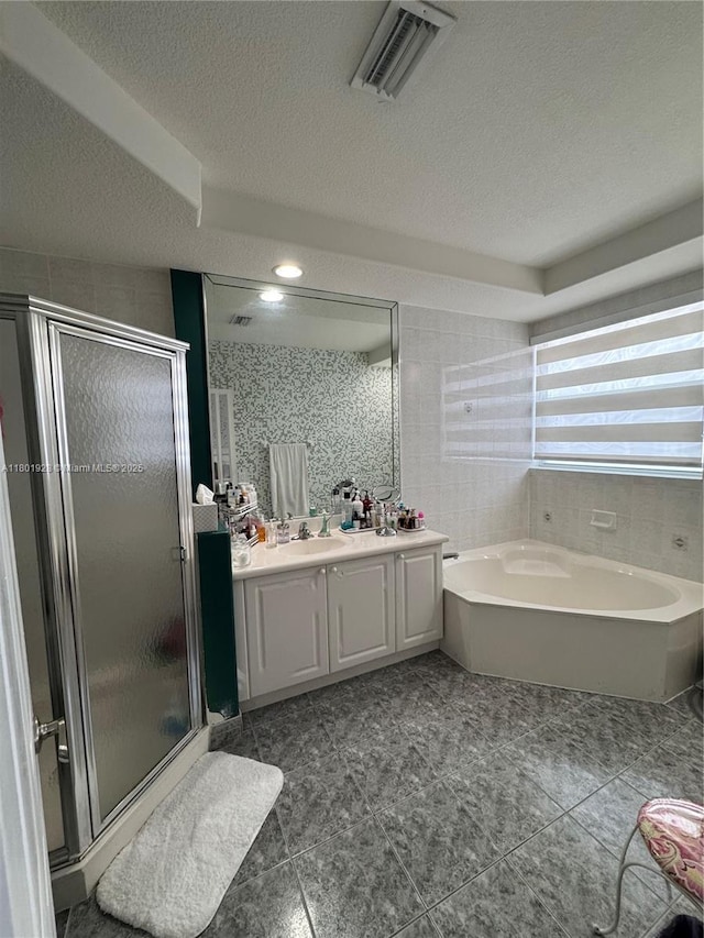 4892 NW 109th Pl, Doral, FL 33178 - bathroom with vanity, a stall shower, a textured ceiling, a garden tub, and tile patterned flooring