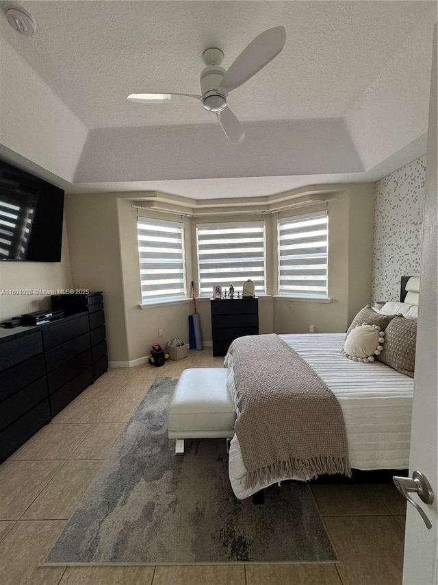 4892 NW 109th Pl, Doral, FL 33178 - bedroom with a raised ceiling, multiple windows, tile patterned flooring, and a textured ceiling