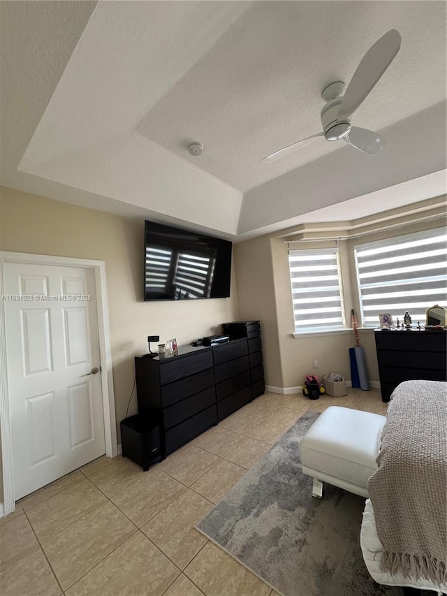 4892 NW 109th Pl, Doral, FL 33178 - bedroom featuring a tray ceiling, light tile patterned floors, a textured ceiling, ceiling fan, and baseboards