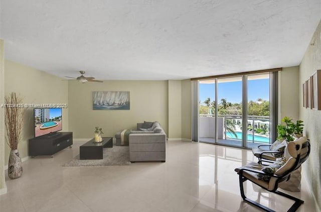 3001 S Ocean Dr Unit 321, Hollywood, FL 33019 - living room with a textured ceiling, ceiling fan, baseboards, floor to ceiling windows, and tile patterned flooring