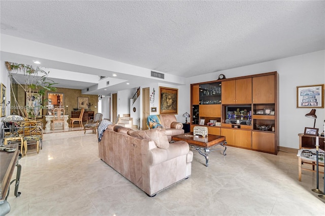 214 Poinciana Dr Unit 204, Sunny Isles Beach, FL 33160 - living area featuring a textured ceiling and stairway