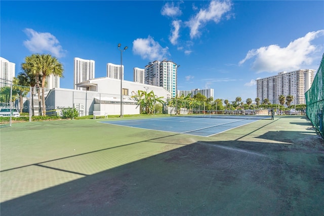 214 Poinciana Dr Unit 204, Sunny Isles Beach, FL 33160 - view of tennis court featuring a view of city and fence