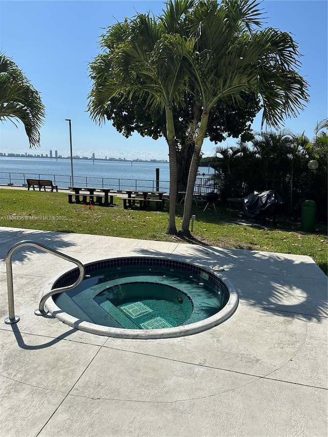 880 NE 69th St Unit 7Q, Miami, FL 33138 - view of swimming pool featuring an in-ground hot tub and a water view