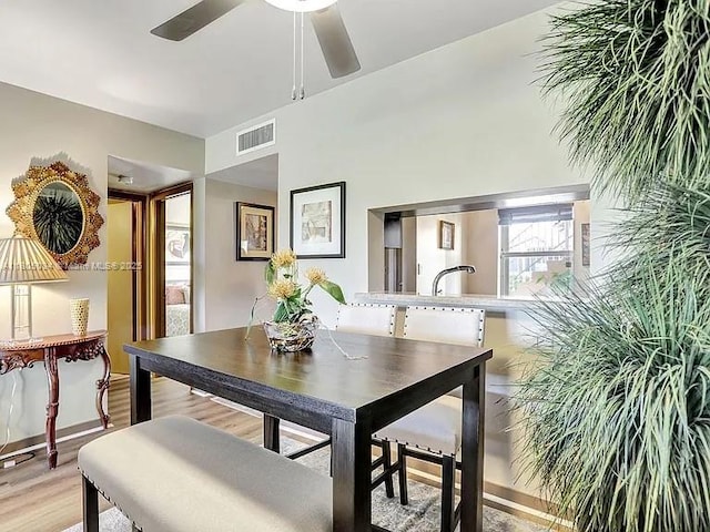 dining space featuring a ceiling fan and light wood-style floors