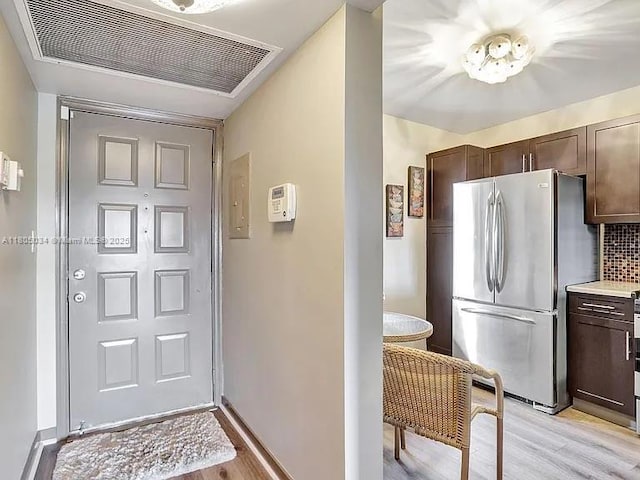 foyer featuring light wood-style floors and baseboards