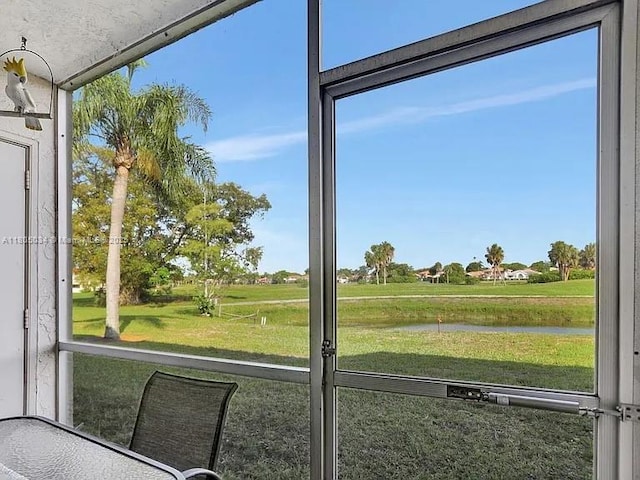 unfurnished sunroom with a water view