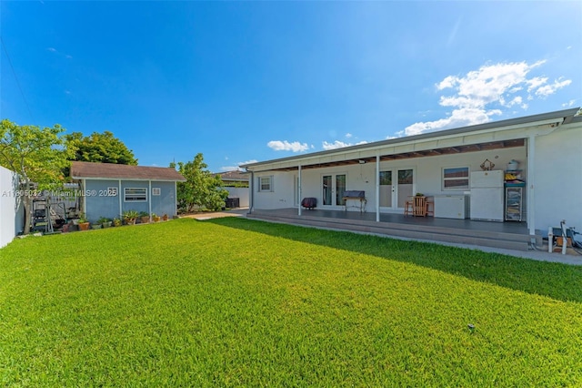 2023 SW 99th Ave, Miami, FL 33165 - rear view of property featuring french doors, an outdoor structure, stucco siding, a patio, and a storage unit