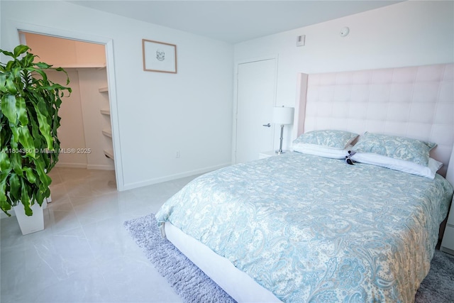 1900 N Bayshore Dr Unit 1918, Miami, FL 33132 - tiled bedroom with baseboards and a walk in closet