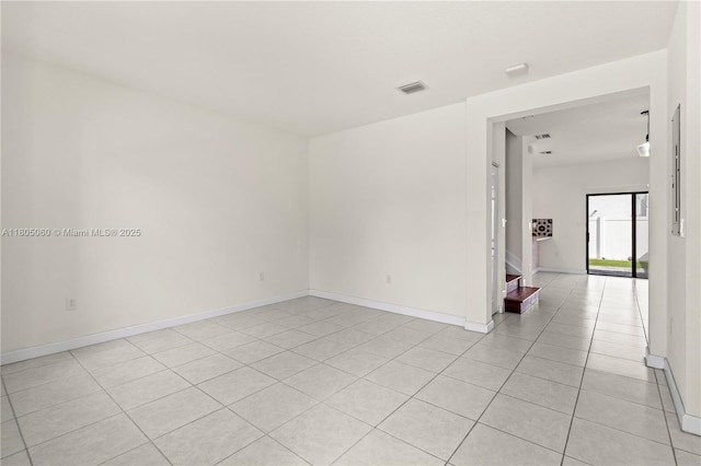 10611 W 33rd Ct, Hialeah, FL 33018 - empty room featuring light tile patterned flooring and stairway