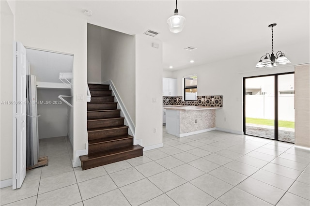 10611 W 33rd Ct, Hialeah, FL 33018 - stairs with tile patterned floors, a chandelier, and recessed lighting
