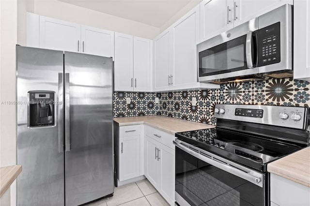 10611 W 33rd Ct, Hialeah, FL 33018 - kitchen featuring appliances with stainless steel finishes, light countertops, white cabinetry, and tasteful backsplash