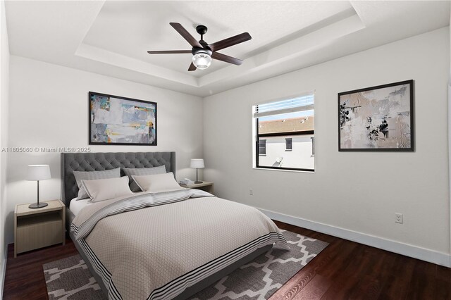 10611 W 33rd Ct, Hialeah, FL 33018 - bedroom featuring a tray ceiling, dark wood-style flooring, and ceiling fan