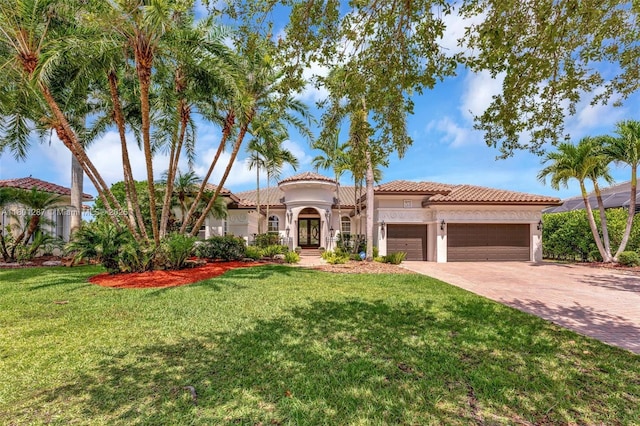 12668 NW 74th Pl, Parkland, FL 33076 - mediterranean / spanish house with french doors, an attached garage, driveway, stucco siding, and a front lawn