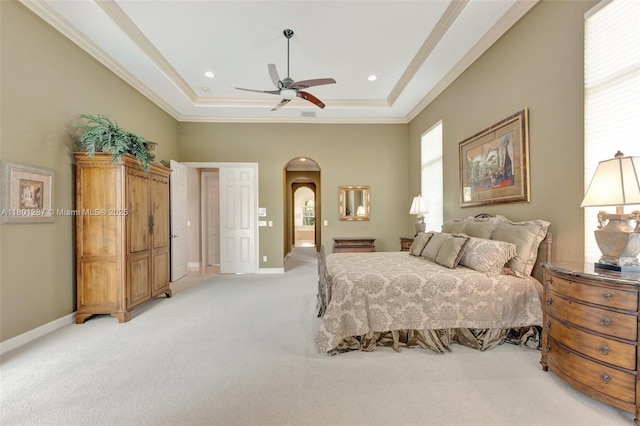 12668 NW 74th Pl, Parkland, FL 33076 - bedroom featuring arched walkways, light colored carpet, a raised ceiling, ornamental molding, and baseboards