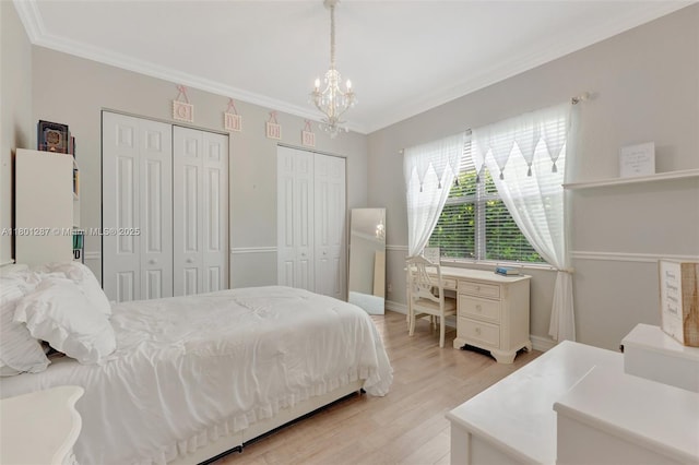 12668 NW 74th Pl, Parkland, FL 33076 - bedroom with multiple closets, a chandelier, light wood-type flooring, and crown molding
