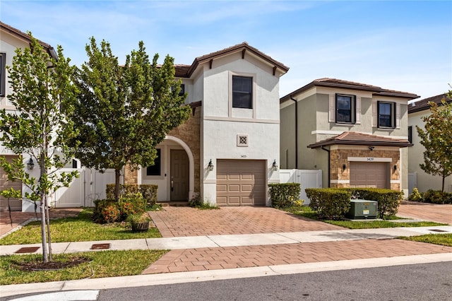 3435 W 110th St, Hialeah, FL 33018 - view of front of home with a garage, decorative driveway, fence, stone siding, and stucco siding
