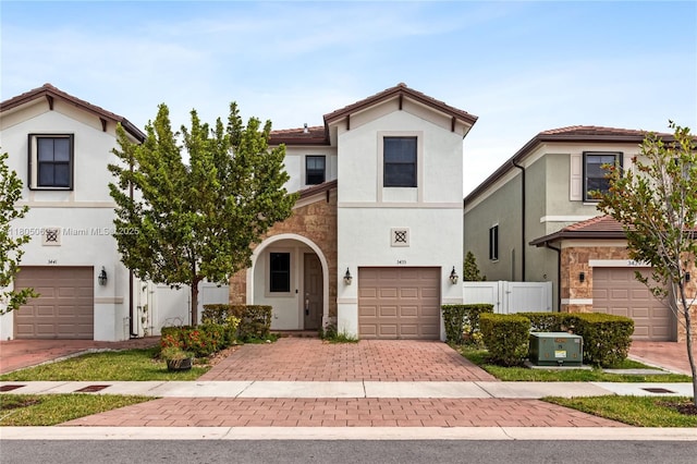 3435 W 110th St, Hialeah, FL 33018 - view of front of property featuring a garage, stucco siding, decorative driveway, fence, and a tile roof
