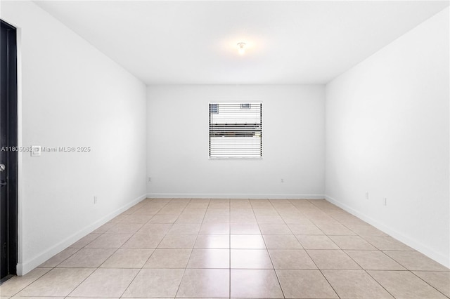 3435 W 110th St, Hialeah, FL 33018 - empty room with light tile patterned floors and baseboards