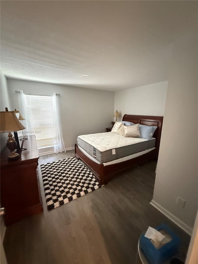 bedroom featuring wood finished floors and baseboards