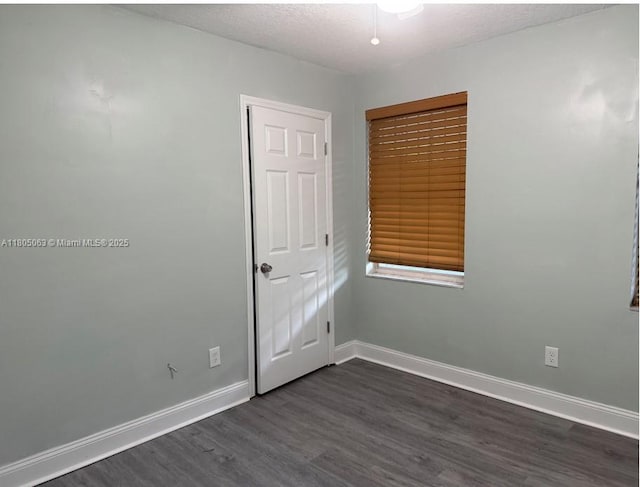 18761 SW 318th Ter, Homestead, FL 33030 - unfurnished bedroom featuring dark wood finished floors and baseboards
