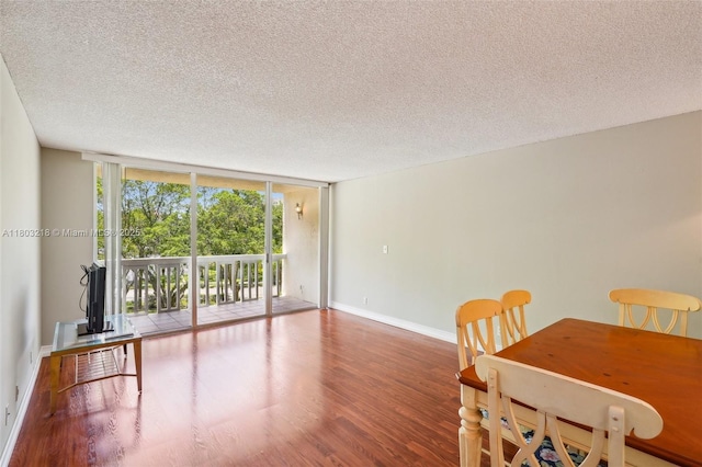 7081 Environ Blvd Unit 243, Lauderhill, FL 33319 - dining space featuring a textured ceiling, wood finished floors, baseboards, and floor to ceiling windows