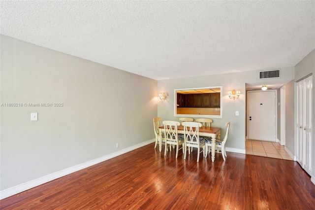 7081 Environ Blvd Unit 243, Lauderhill, FL 33319 - dining space featuring a textured ceiling, wood finished floors, and baseboards