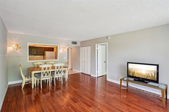 7081 Environ Blvd Unit 243, Lauderhill, FL 33319 - dining area featuring a textured ceiling, wood finished floors, and baseboards