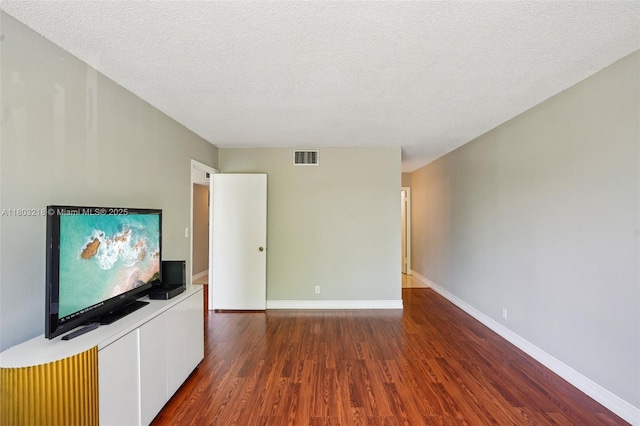 7081 Environ Blvd Unit 243, Lauderhill, FL 33319 - unfurnished living room with wood finished floors, baseboards, and a textured ceiling