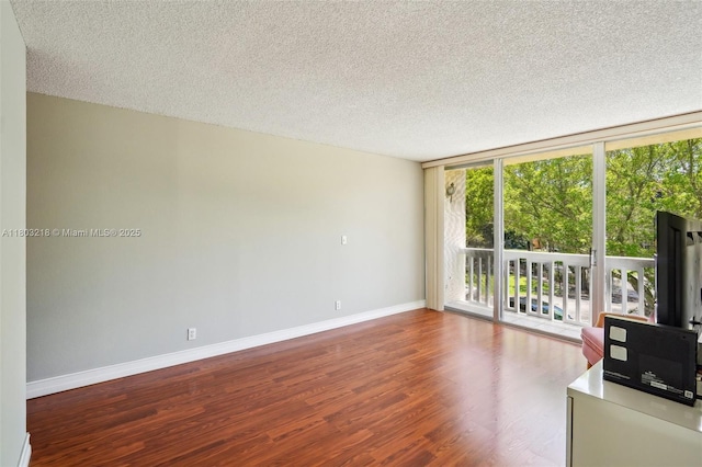 7081 Environ Blvd Unit 243, Lauderhill, FL 33319 - unfurnished living room with wood finished floors, a textured ceiling, and expansive windows