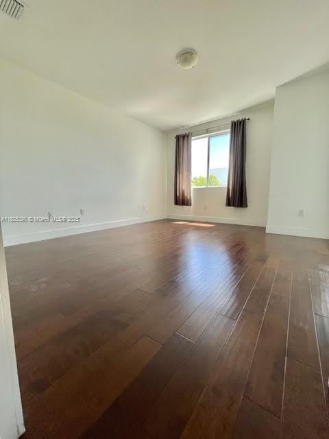 unfurnished room featuring wood finished floors and baseboards