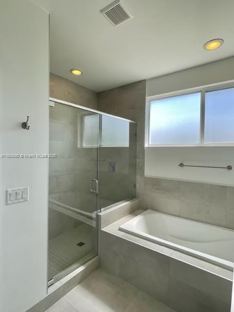 full bathroom featuring a bath, tile patterned floors, a stall shower, and recessed lighting