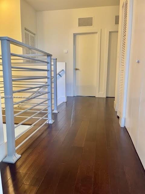 corridor with wood-type flooring