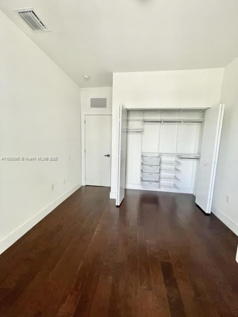 unfurnished bedroom with baseboards and wood finished floors