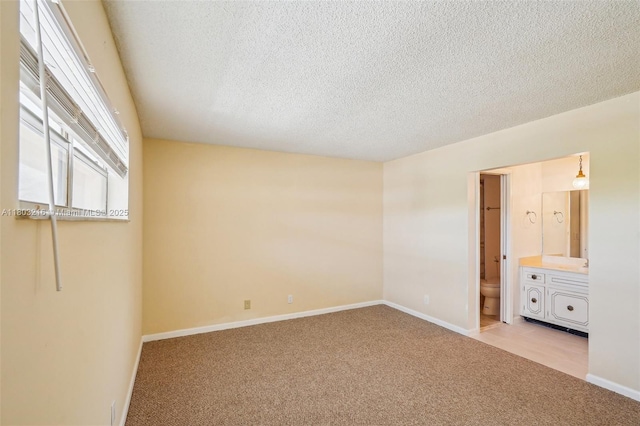 3774 Inverrary Blvd Unit 203P, Lauderhill, FL 33319 - unfurnished bedroom featuring light carpet, a textured ceiling, and connected bathroom