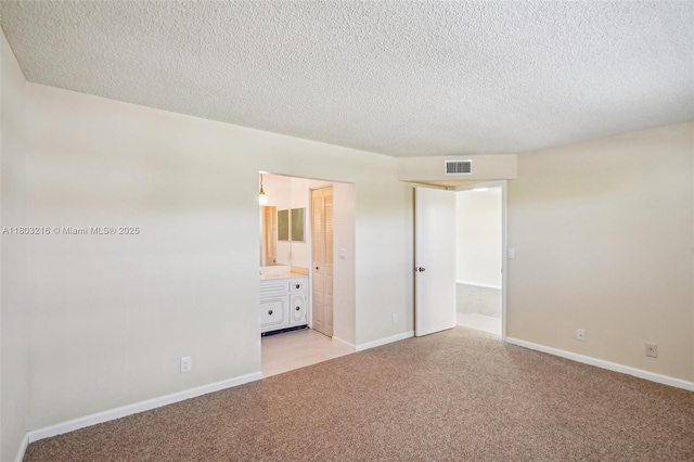 3774 Inverrary Blvd Unit 203P, Lauderhill, FL 33319 - unfurnished bedroom with light carpet, a textured ceiling, and ensuite bathroom