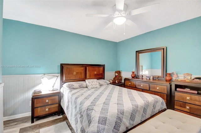 8113 SW 22nd Ct Unit 150, Davie, FL 33324 - bedroom with light wood-type flooring, a wainscoted wall, and ceiling fan