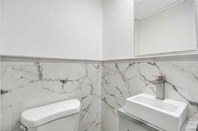 8113 SW 22nd Ct Unit 150, Davie, FL 33324 - half bath featuring tile walls, a textured wall, toilet, and vanity