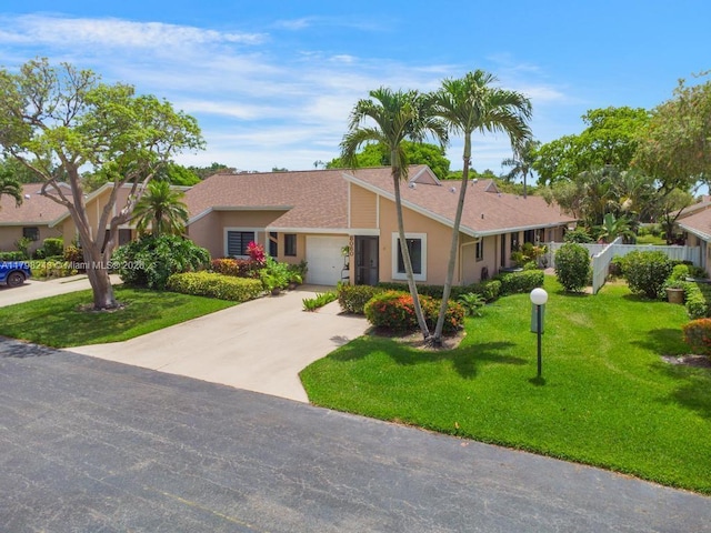 8080 Sweetbriar Way, Boca Raton, FL 33496 - view of front of home with stucco siding, an attached garage, driveway, and a front yard