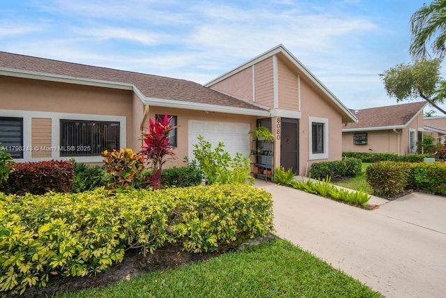 8080 Sweetbriar Way, Boca Raton, FL 33496 - mid-century modern home with a garage, stucco siding, and concrete driveway