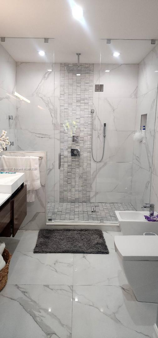 155 W 60th St, Hialeah, FL 33012 - full bathroom featuring toilet, a marble finish shower, and vanity