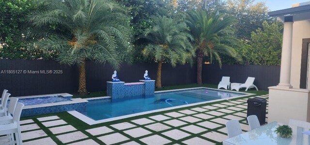 155 W 60th St, Hialeah, FL 33012 - view of pool featuring a fenced backyard, a patio area, and a pool with connected hot tub