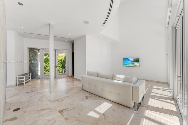 544 Fernwood Rd Unit 544, Key Biscayne, FL 33149 - living room featuring light marble finish flooring, recessed lighting, baseboards, and a towering ceiling