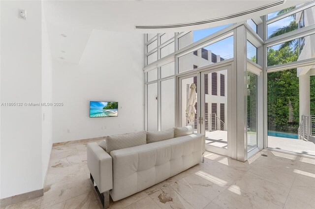544 Fernwood Rd Unit 544, Key Biscayne, FL 33149 - living room with light marble finish floors, baseboards, and a towering ceiling