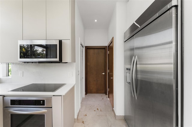 544 Fernwood Rd Unit 544, Key Biscayne, FL 33149 - kitchen featuring appliances with stainless steel finishes, modern cabinets, white cabinetry, light countertops, and recessed lighting